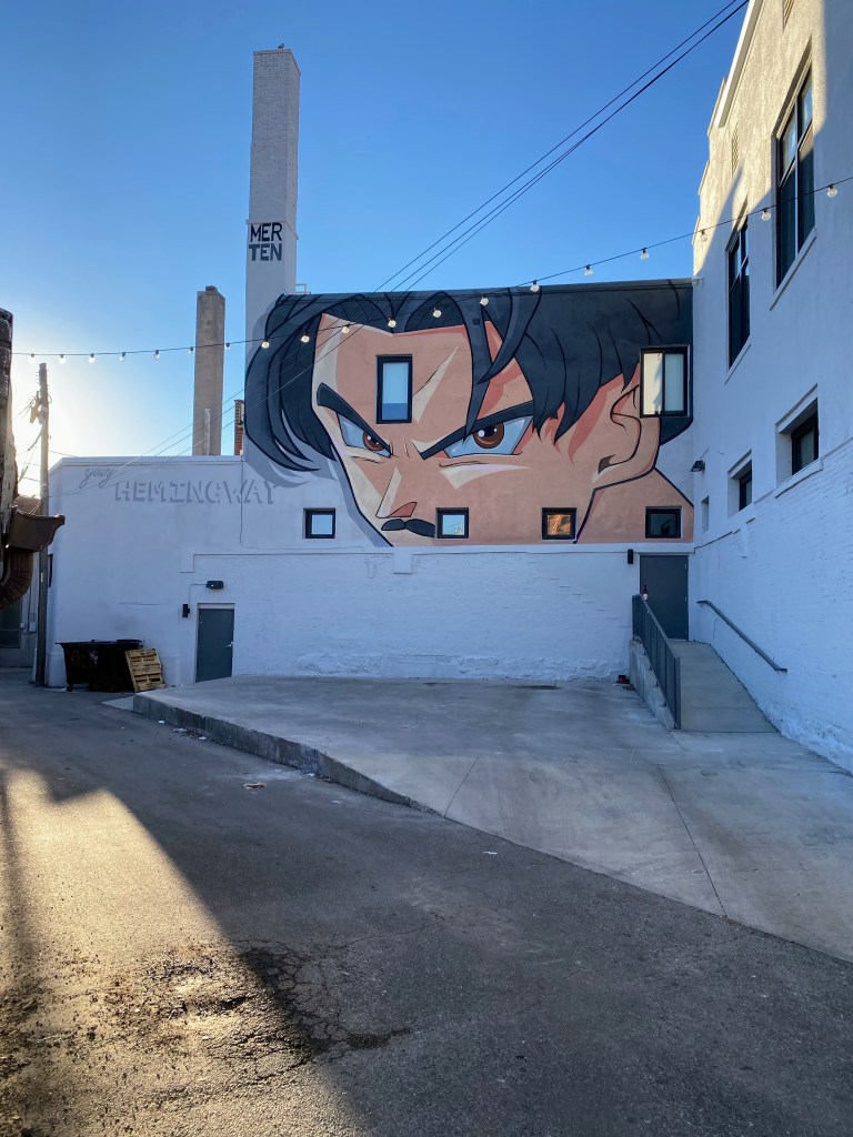 At the rear of the Hemingway Building is this mural depicting a young Ernest Hemingway. The portrait was created by artist Jake Merten in an anime style